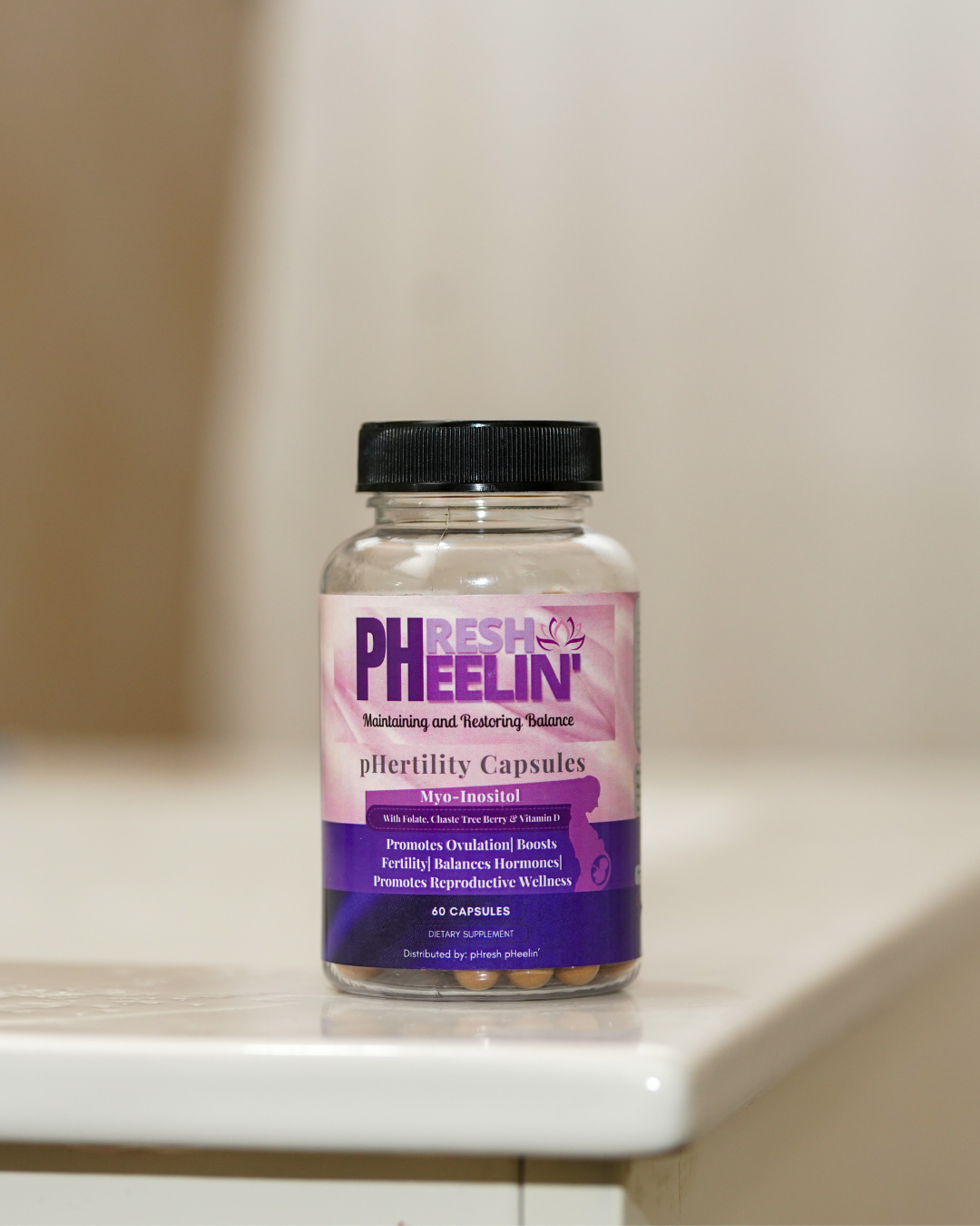 Bottle of pHresh pHeelin' pHertility capsules on a white surface with a neutral background