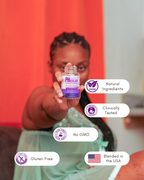 Person holding a bottle labeled pHertility Capsules with certification icons on a blurred background