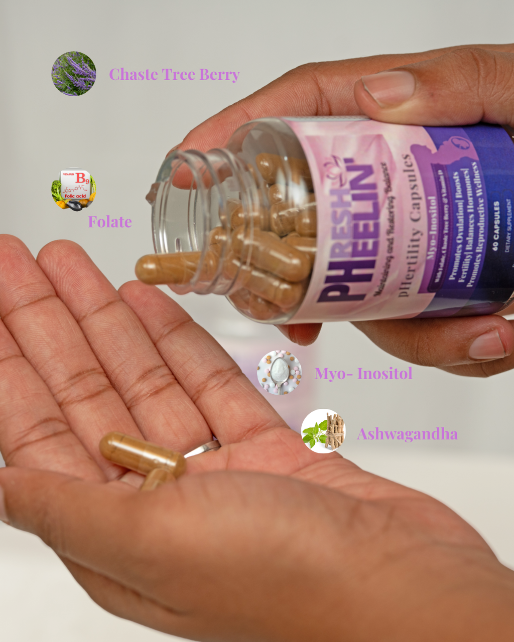 Hand holding a bottle of pHertility Capsules with visible ingredients on a white background
