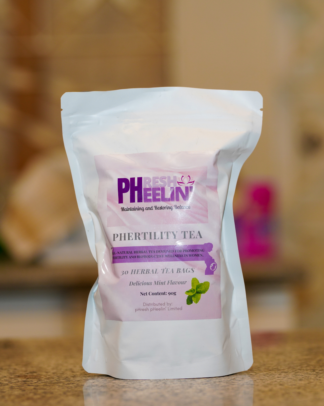 pHresh pHeelin' pHerility Tea package on a wooden surface with a blurred background
